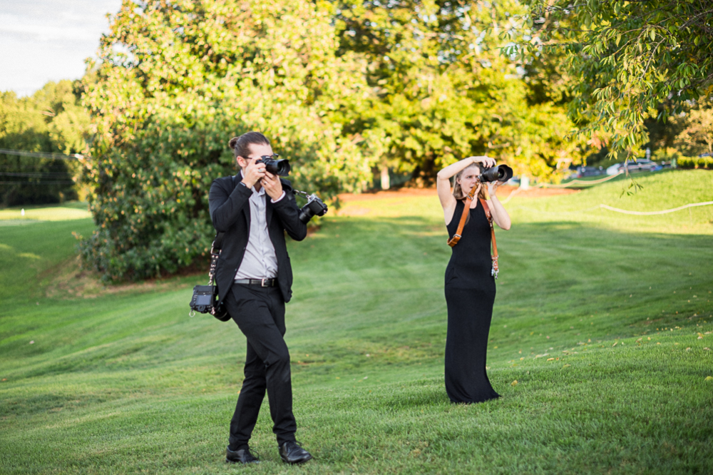 Couple dressed professionally photographing a wedding