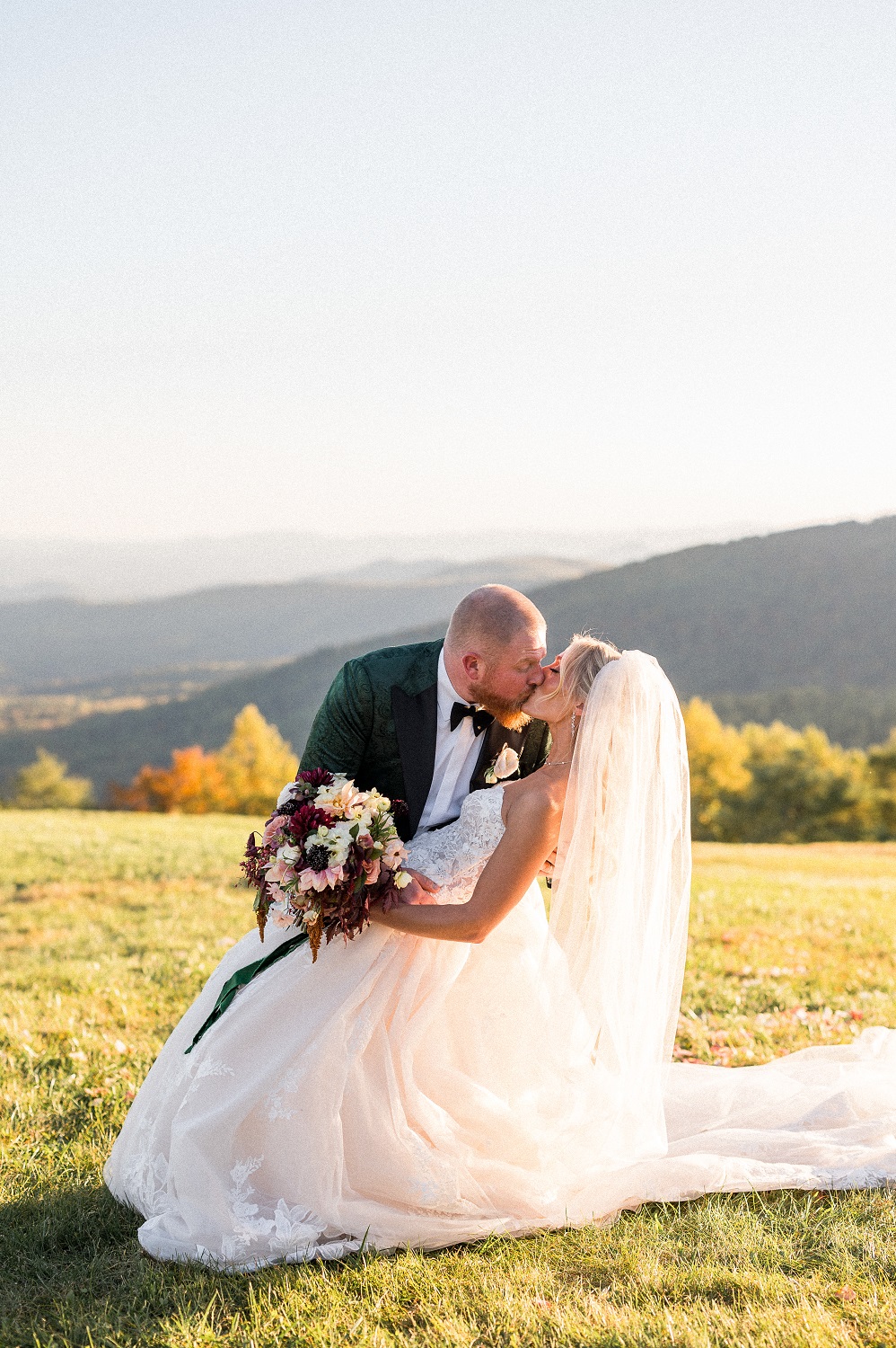 A bride and groom kiss on their wedding day, hosted at a private estate outside Stanardsville, VA -- photographed by Hunter and Sarah Photography