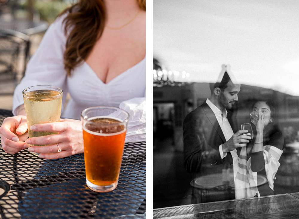 A couple laughs together over two pint glasses full of craft beer during their engagement photoshoot at Blue Mountain Brewery outside Charlottesville, VA